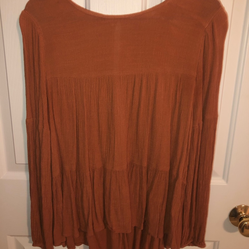 Burnt orange peplum top.